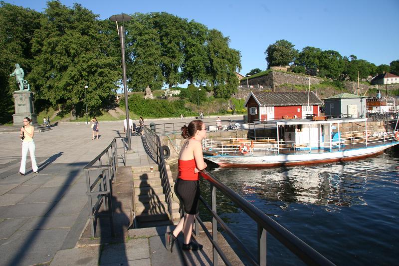 Woman in front of a harbour looking at the water in Oslo, Norway
